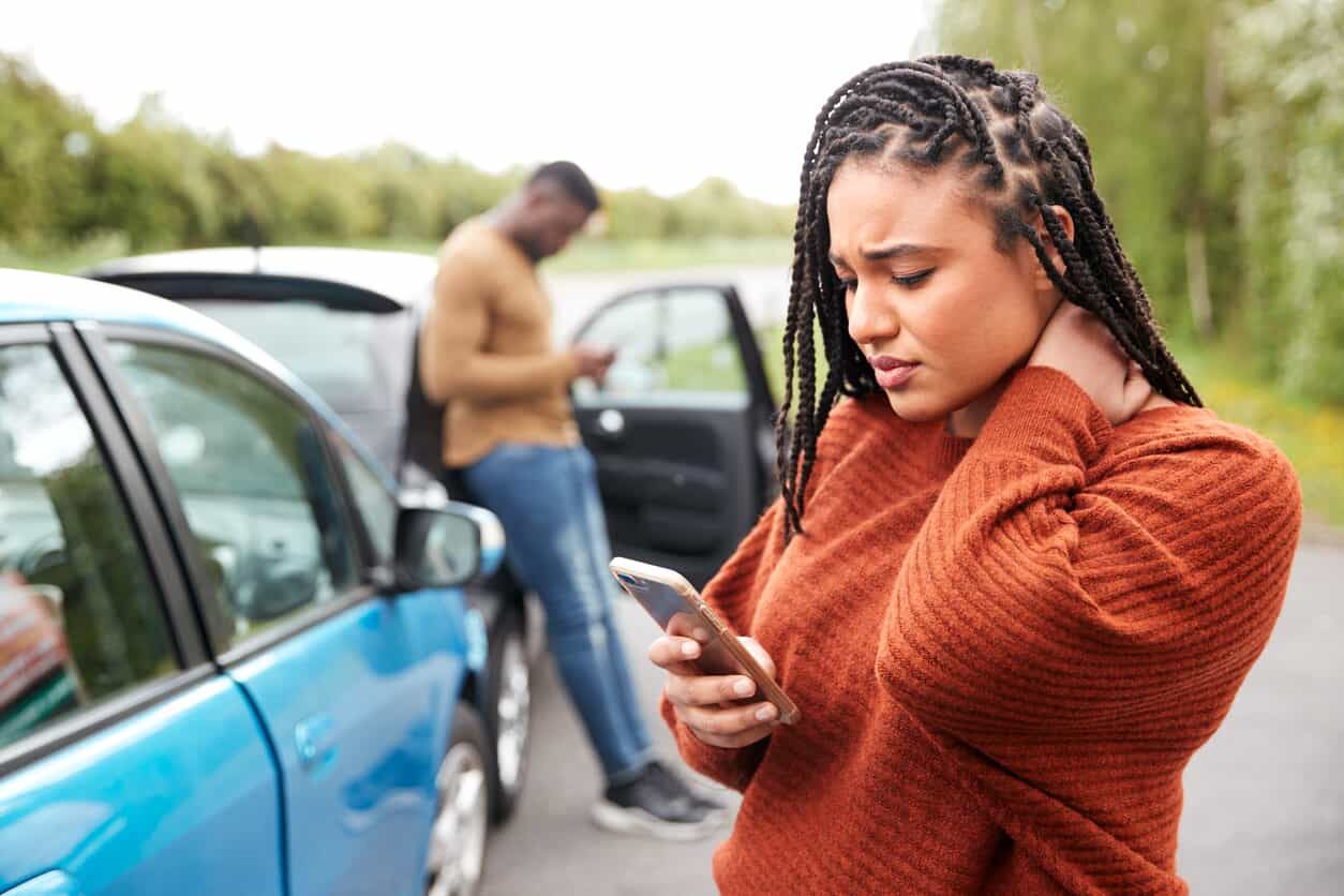 Woman holding her neck after a car accident